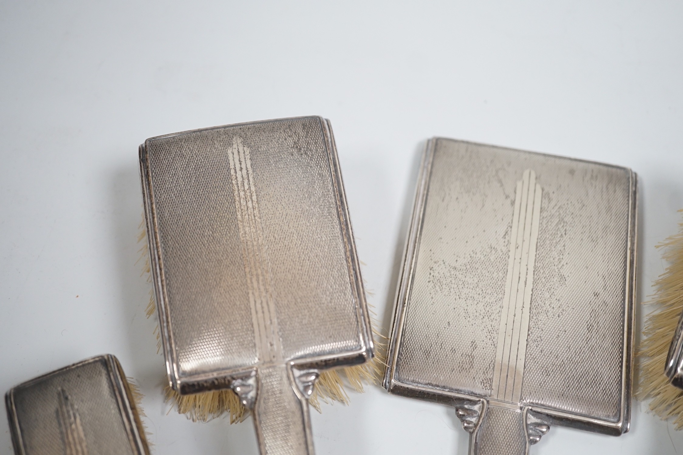 A 1930's Art Deco silver mounted five piece brush and mirror set, Birmingham, 1937.